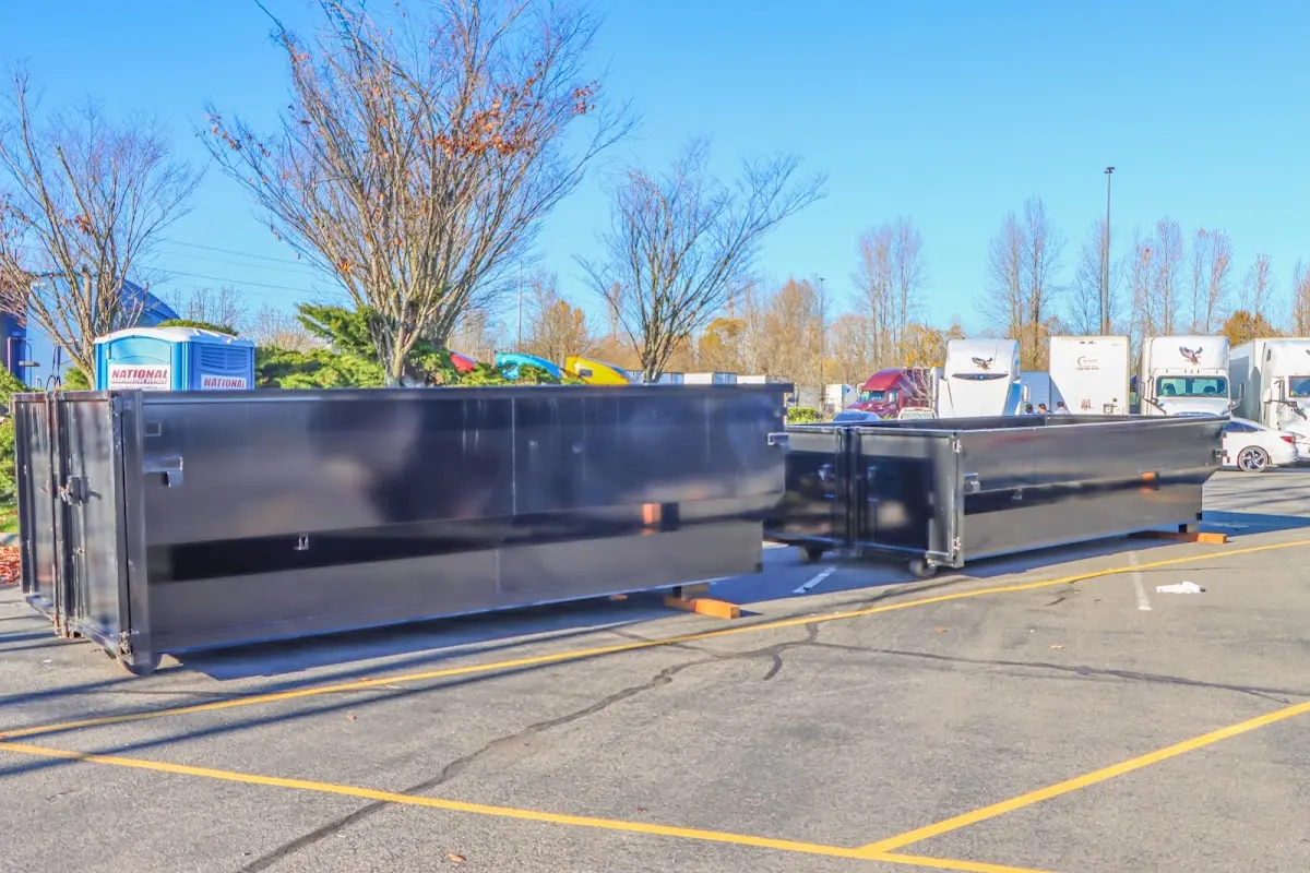Professional dumpster rental service with roll-off container on residential driveway in North Londonderry